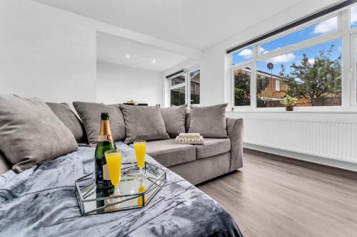 a living room with a couch and a bottle of champagne at LODGEselect in Thamesmead