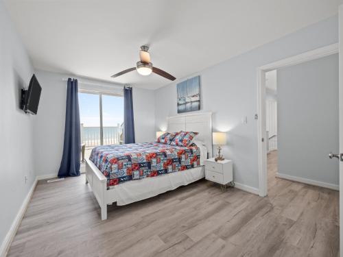a bedroom with a bed and a view of the ocean at Oceanfront vacation home - EAST in Emerald Isle