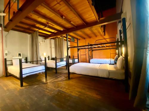 a bedroom with two beds in a room at Casa Regina CDMX in Mexico City