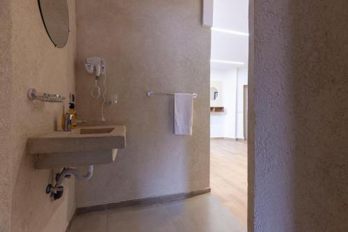 a bathroom with a sink and a mirror at Taghazout Waves Surf camp & Hotel in Aourir