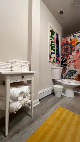 a bathroom with a white table and a toilet at Casa Pinturella in Silver Spring