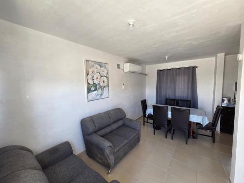 a living room with a couch and chairs and a table at Casa VP en Fraccionamiento in Ciudad Acuña