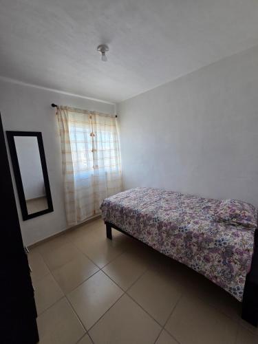 a bedroom with a bed and a mirror in it at Casa VP en Fraccionamiento in Ciudad Acuña