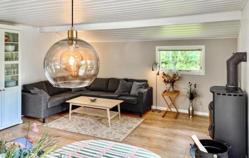 a living room with a couch and a table at Spætten in Brovst