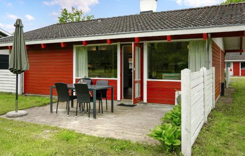 a patio with a table and chairs in front of a house at Golfparken in Aabenraa