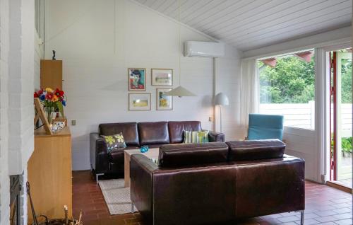 a living room with a leather couch and chairs at Golfparken in Aabenraa