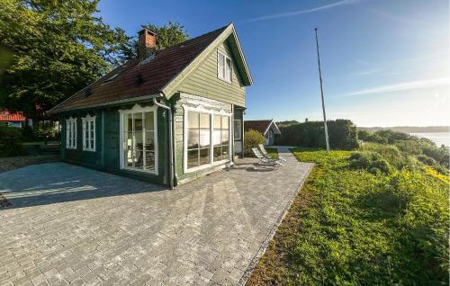 a small green house with a large patio at Nice Home In Haderslev With Wifi in Haderslev