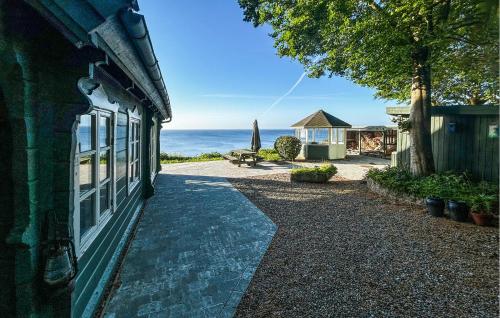a walkway next to a building with a view of the ocean at Nice Home In Haderslev With Wifi in Haderslev
