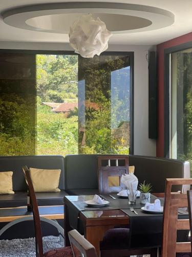 a dining room with a table and chairs and a window at Los Lirios Hotel Merida in Mérida
