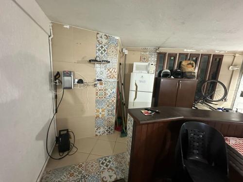 a bathroom with a shower and a sink in a room at Coffehouse - Casa com Piscina in São Vicente