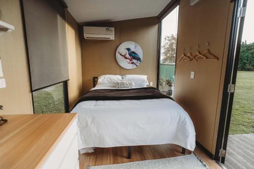 a bedroom with a large bed in a house at Matariki Akura by Tiny Away in Masterton