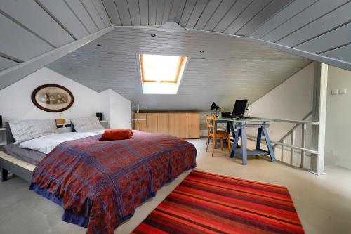 a bedroom with a bed and a desk in a attic at Pawlansky Apartments in Prague