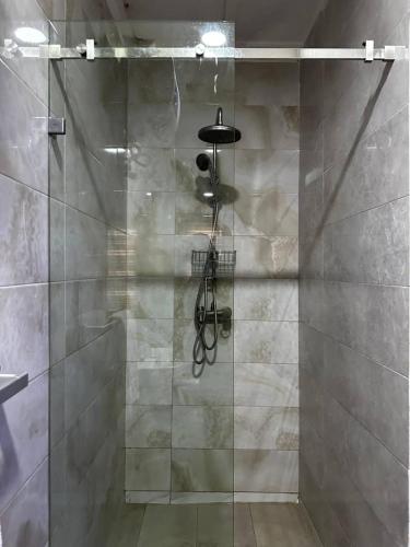 a shower with a glass door in a bathroom at ModexD'Crib in Lagos