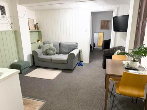 a living room with a couch and a table at Barossa Palms Motel in Nuriootpa