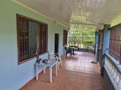 a room with a porch with chairs and a table at Quinta los almendros in Jabillos