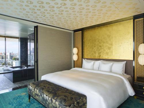 a bedroom with a large bed and a large window at Espacio Nagoya Castle, The Leading Hotels of the World "LHW" in Nagoya