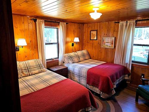 a bedroom with two beds in a wooden cabin at Black Hawk in Mercer