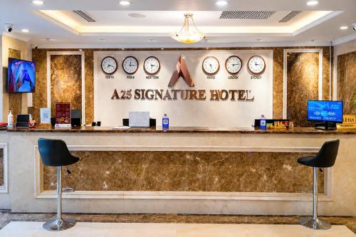 signature hotel lobby with clocks on the wall at A25 Signature Hotel in Hanoi