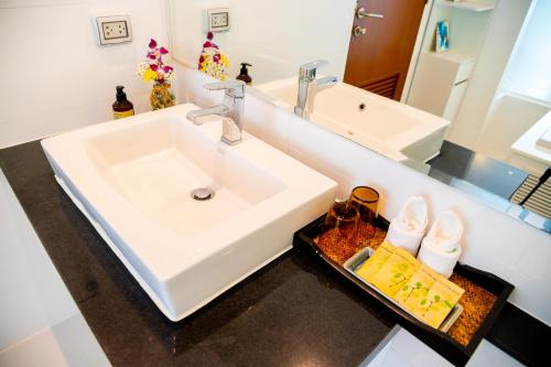 a bathroom with a sink and a mirror at Krabi One Bedroom Pool View in Klong Muang Beach