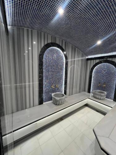 Ein Zimmer mit zwei großen Fenstern und weißem Fliesenboden in der Unterkunft Platinum Hôtel Spa Abidjan Cocody in Abidjan