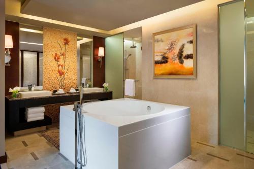 a bathroom with a large tub and two sinks at The Imperial Mansion, Beijing - Marriott Executive Apartments in Beijing