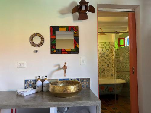 a bathroom with a gold sink and a tub at La Puerta - Pueblito Boyacense in Duitama