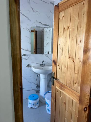 a bathroom with a sink and a mirror at Snow Den hostel in Leh