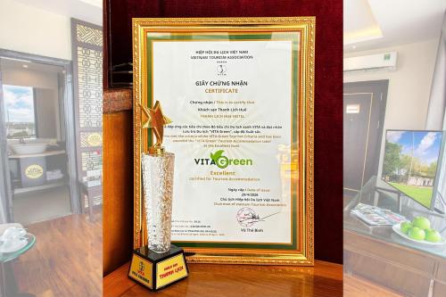 a picture of a winners trophy and a picture of a vase at Thanh Lich Hue Hotel in Hue