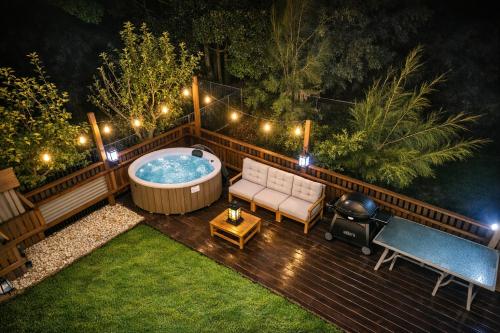 a backyard deck with a jacuzzi tub at night at Fishers Villa - Crescent Head in Crescent Head