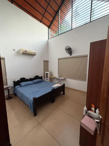 a bedroom with a bed and a projection screen at Bodhi nila private villa in Irimbranallūr