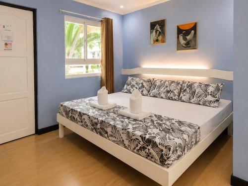 a bedroom with a bed with two candles on it at Joaquinn's Bed and Breakfast El Nido City near Beach in El Nido