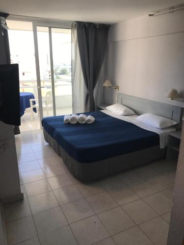 a bedroom with a bed with towels on it at Bamboli Holidays in Playa de las Americas