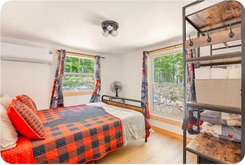 a bedroom with a bed and a window and a ladder at Serenity Cabin - Cozy Mountain retreat near Shenandoah National Park in Luray