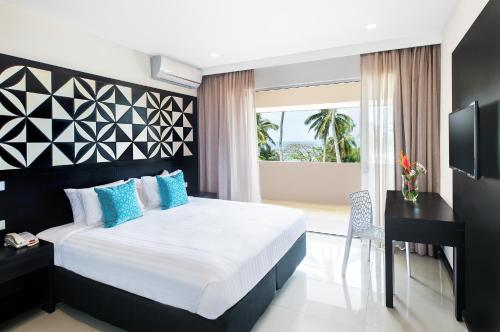 Tempat tidur dalam kamar di Tanoa International Dateline Hotel