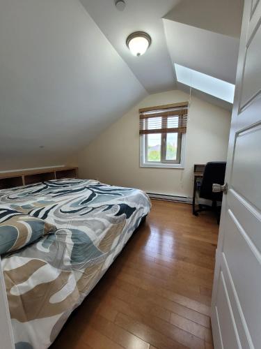 a bedroom with a bed and a window at Private Room in Guest House, Near the New Oakridge Mall & Transit - Near Langara 49th Station in Vancouver