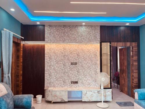 a room with a desk and a fan in a room at Soar Serenity Homes in Pithorāgarh