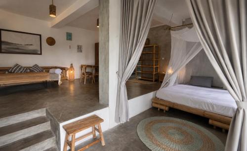 a bedroom with a bed with a canopy at Vertical House Bali in Uluwatu