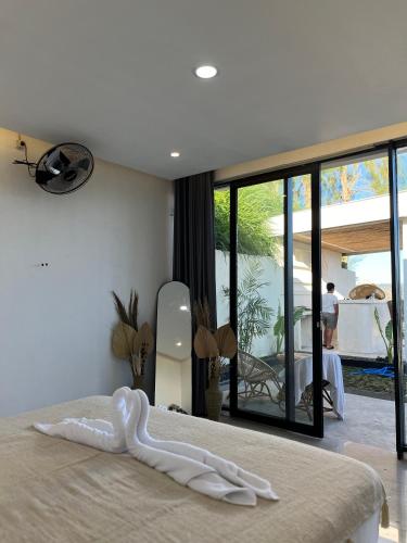 a bed with a white towel on it in a bedroom at Rumah pinggan private pool in Kubupenlokan