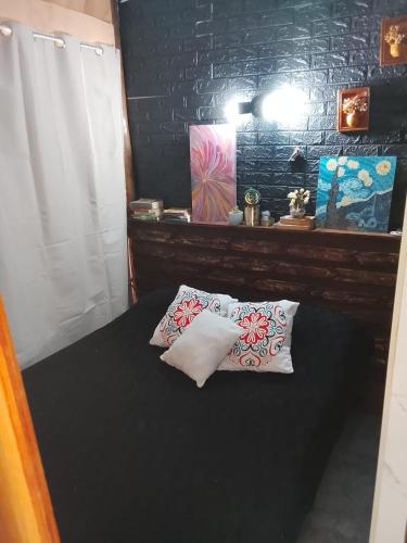 a bedroom with a bed with two pillows on it at Gather in Balneario Argentino
