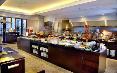 a buffet line in a restaurant with food on display at ASTON Bogor Hotel and Resort in Bogor