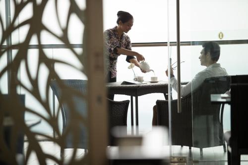 two people sitting at a table in a restaurant at InterContinental Bandung Dago Pakar by IHG in Bandung