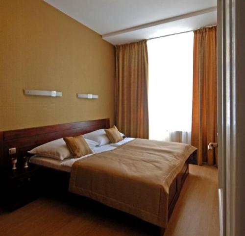 a bedroom with a bed with a large window at U Stare Pani - At the Old Lady Hotel in Prague
