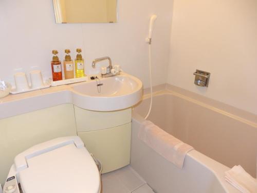 La salle de bains est pourvue d'un lavabo, de toilettes et d'une baignoire. dans l'établissement Hotel Hashimotorou, à Ishioka