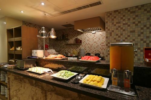 a kitchen with several plates of food on a counter at Taipei Fullerton Hotel - South in Taipei