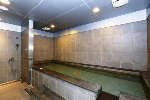 an indoor swimming pool in a room with tile walls at Taipei Fullerton Hotel - South in Taipei