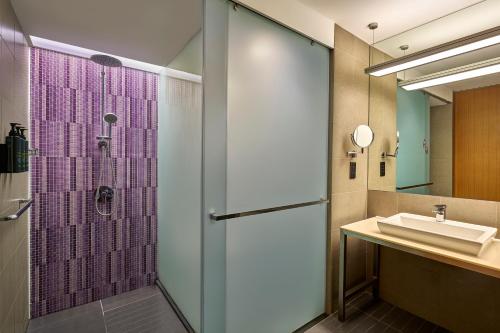a bathroom with a shower and a sink at Aloft by Marriott Kuala Lumpur Sentral in Kuala Lumpur
