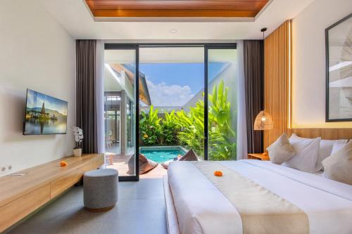 a bedroom with a large bed and a large window at Ellavie Villa Ubud in Ubud