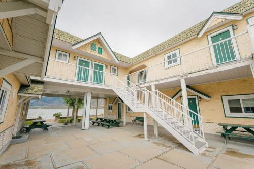a building with a staircase and a patio at Studio Suite 8 Green Gables Resort in Osoyoos