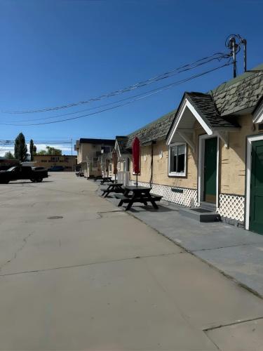 a row of buildings with picnic tables on the street at Studio Suite 8 Green Gables Resort in Osoyoos