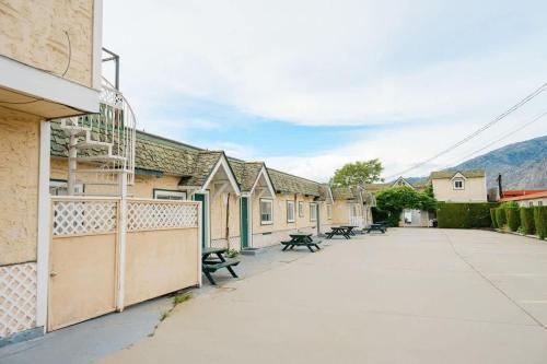 a row of buildings with benches on a street at Studio Suite 7 at Green Gables Resort in Osoyoos